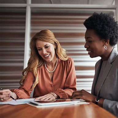 Two businesswomen reviewing documents.