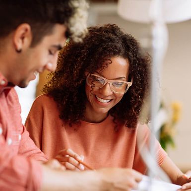 Young man and woman looking at a document together.