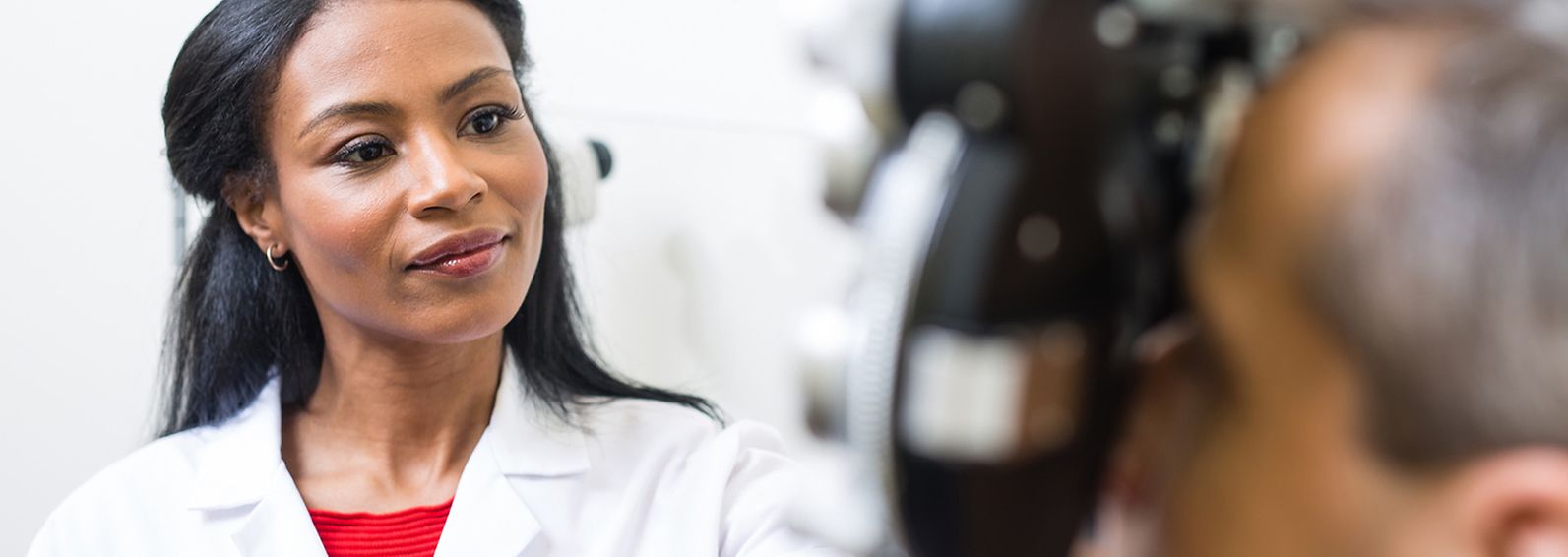 An optometrist examining a patient's eyes.